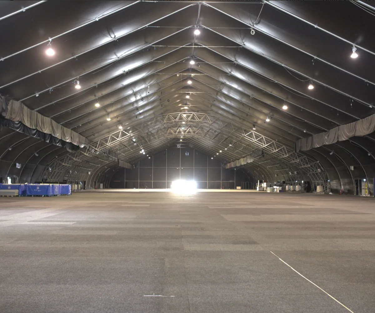 The empty exhibition floor at the Malta Fairs and Conventions Centre, a vaulted hall with exposed steel roof trusses